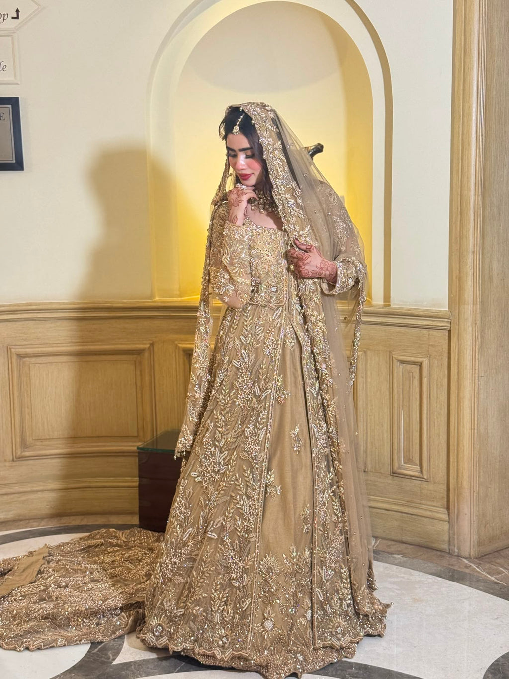KANZARA Sehrish champagne gold bridal gown with dupatta draped over the head