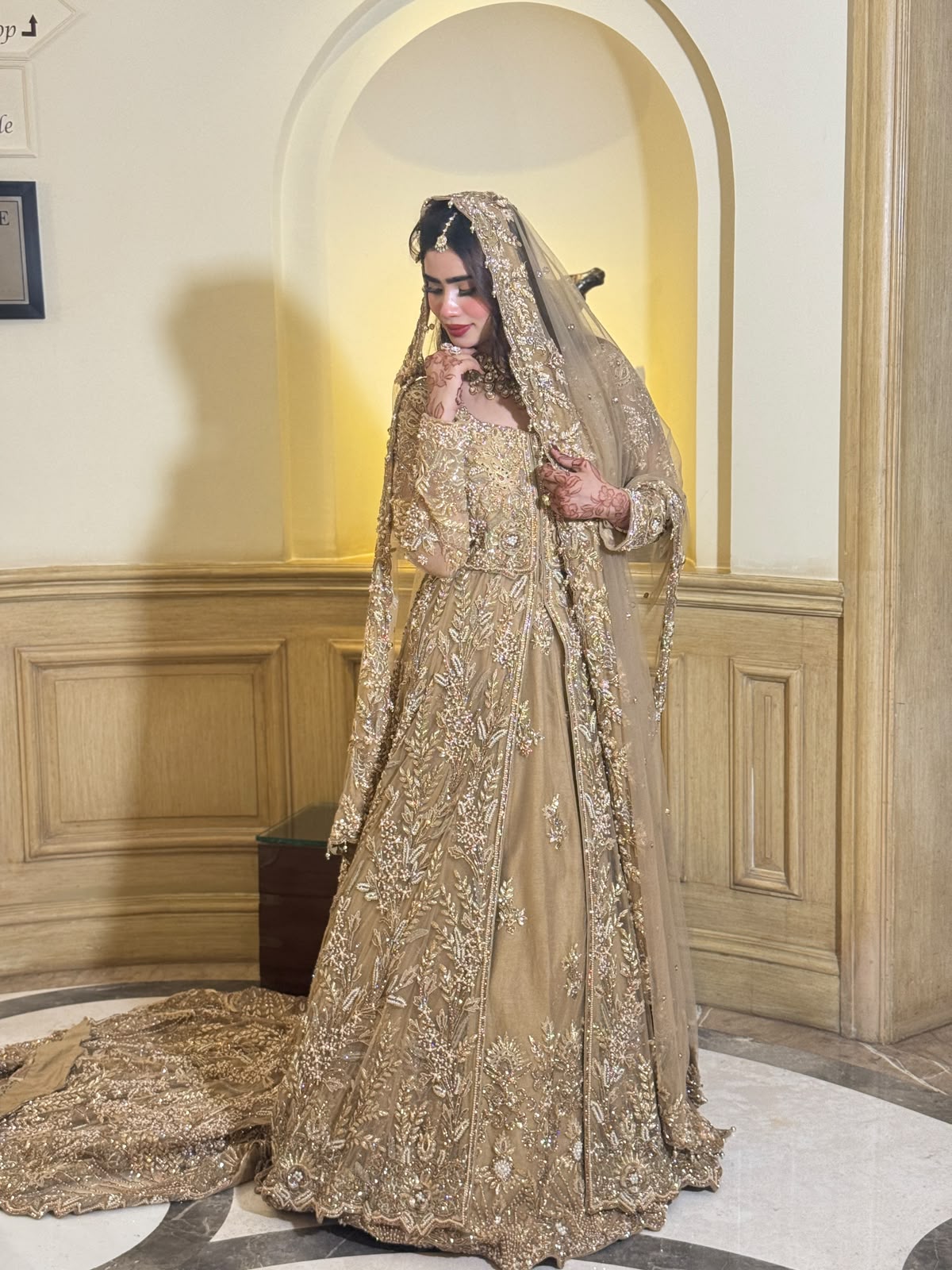 KANZARA Sehrish champagne gold bridal gown with dupatta draped over the head