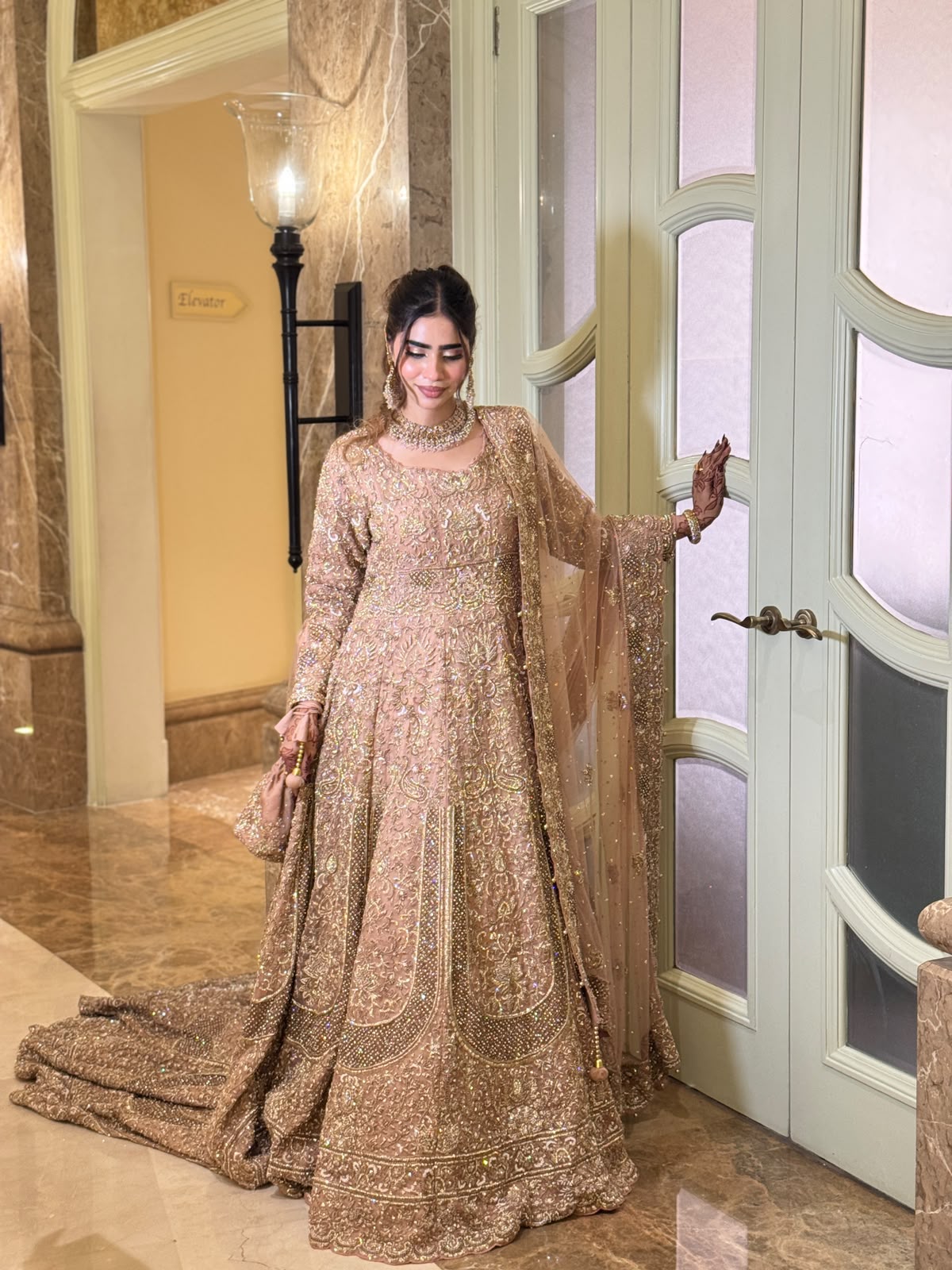 Full view of the KANZARA Rukhsar rose gold bridal lehenga with pearl-edged dupatta