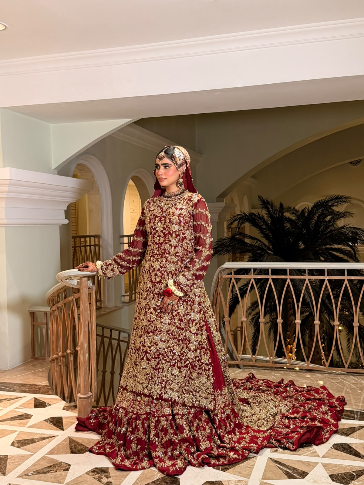 Full view of the KANZARA Gulnaar bridal gown with net dupatta draped over the head