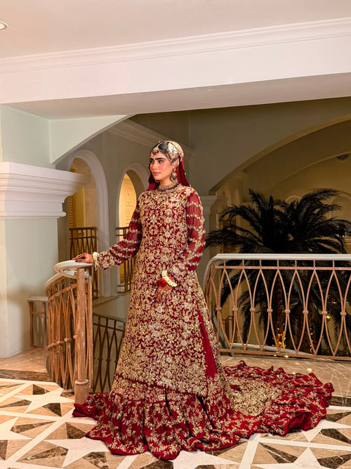 Full view of the KANZARA Gulnaar bridal gown with net dupatta draped over the head